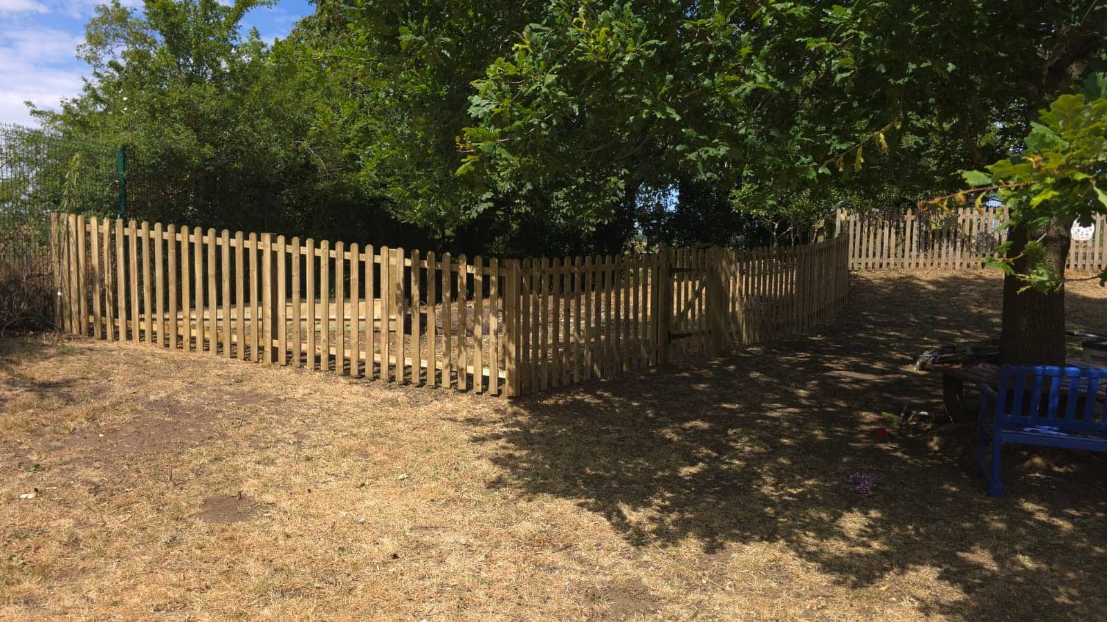 New treated-timber picket fencing and access gate enclosing the school pond area