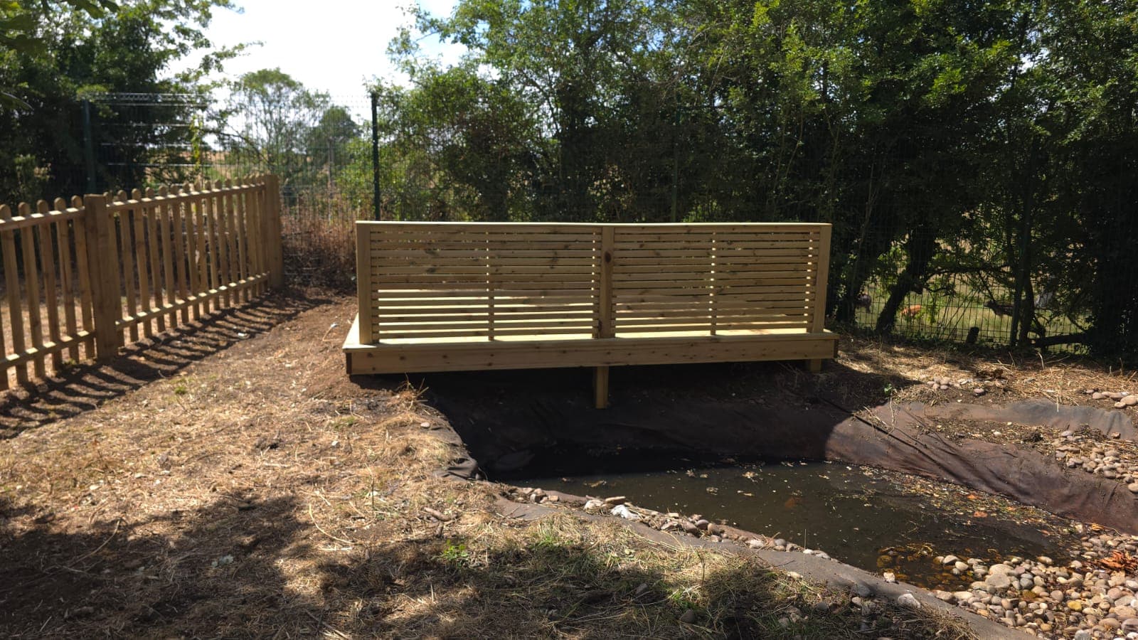 Side view of the new timber deck crossing the pond