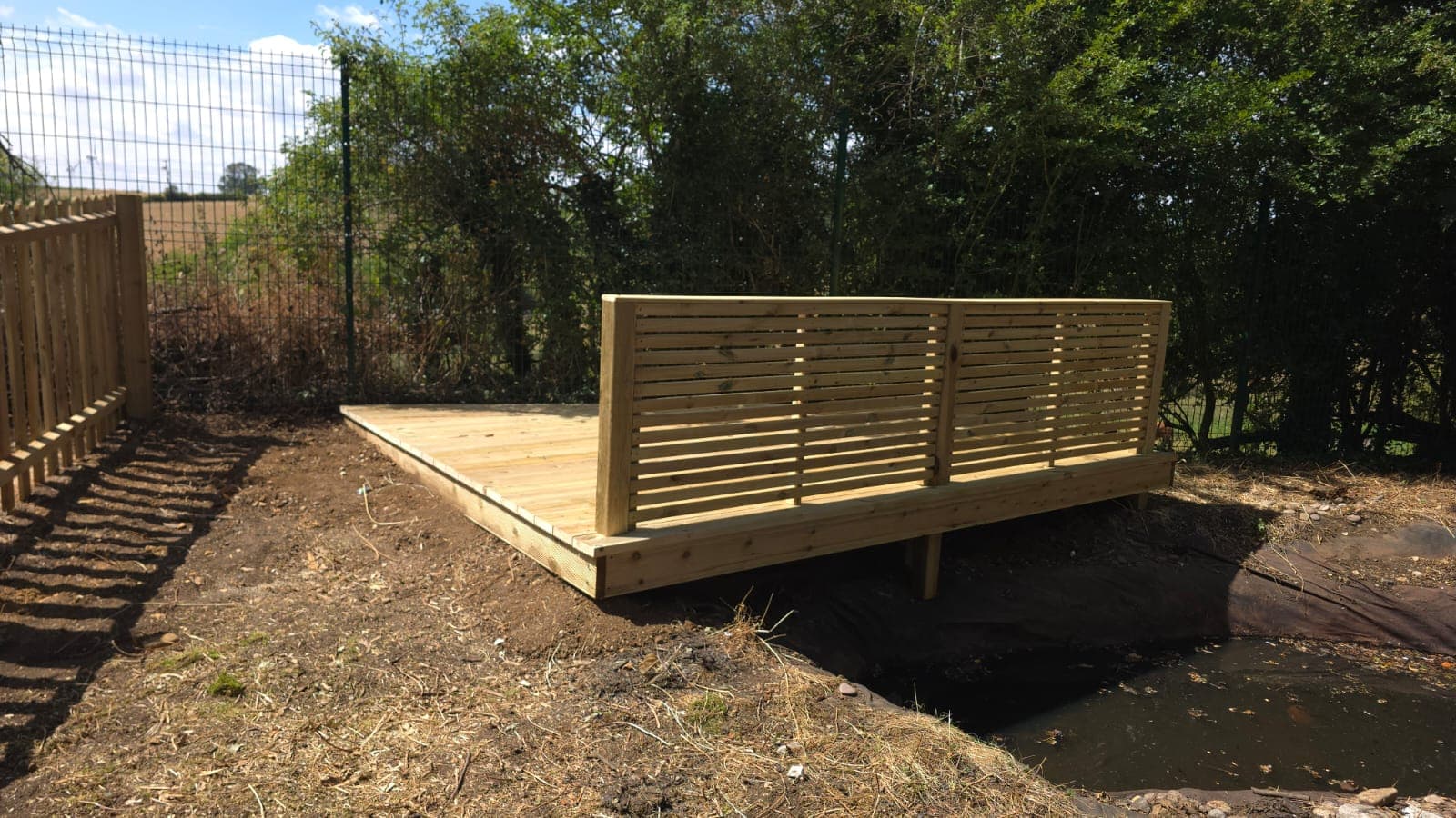 Close view of the horizontal slatted balustrade on the new pond deck